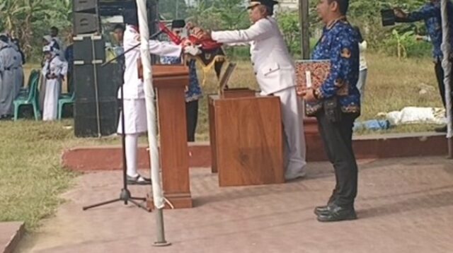 Upacara HUT ke-81 Kemerdekaan RI di Kecamatan Arjawinangun dengan Camat Arjawinangun menyerahkan bendera Merah Putih kepada petugas pengibar bendera, disaksikan peserta upacara